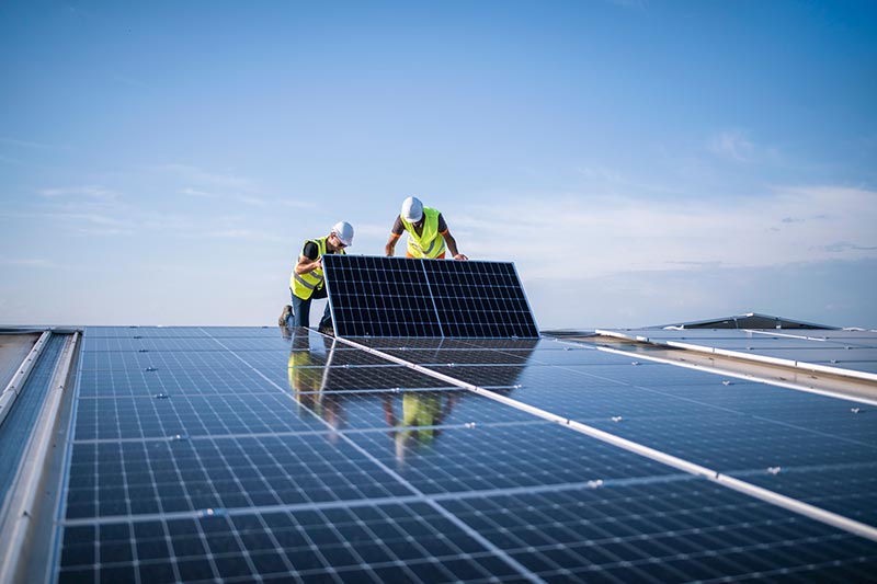 technicians installing solar panels